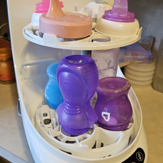 Baby Brezza bottle washer loaded with bottles and parts.